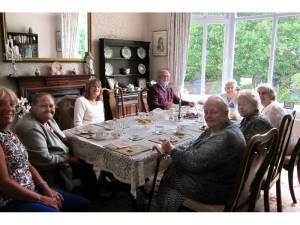 Local residents enjoy and afternoon tea with Ron, their volunteer driver for the day.
